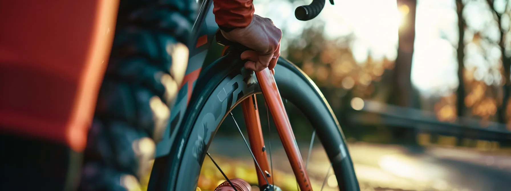 a close-up shot of a cyclist holding an inflated rene herse tpu tube for a 700c wheel.